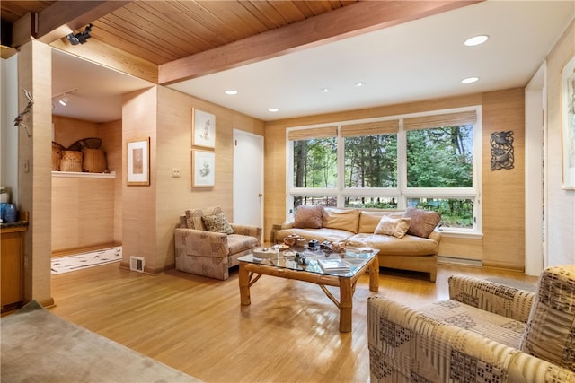 living room featuring beam ceiling, wood ceiling, and light wood-type flooring