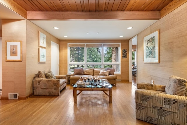 living room featuring beam ceiling, wooden ceiling, and light wood-type flooring