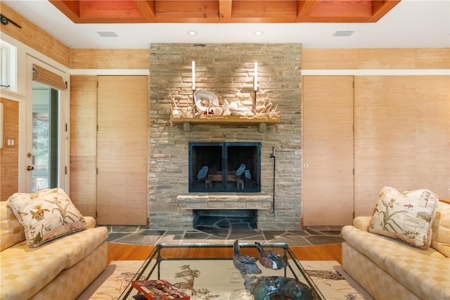 living room with beam ceiling, wood-type flooring, and a fireplace