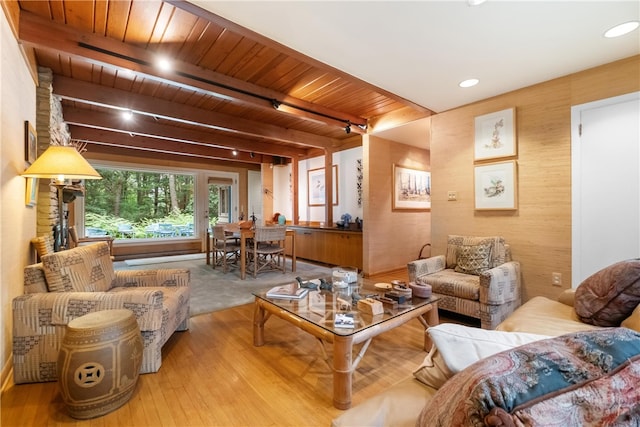 living room with beam ceiling, light hardwood / wood-style floors, and wooden ceiling