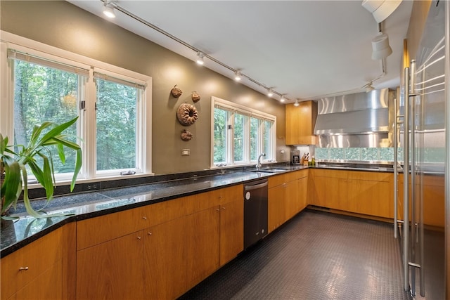 kitchen featuring wall chimney exhaust hood, dishwasher, sink, and plenty of natural light