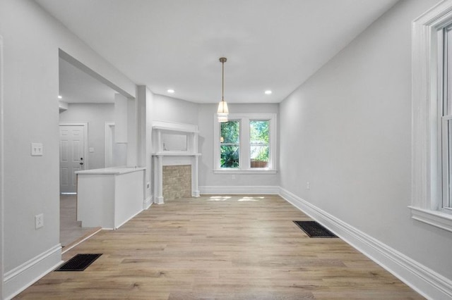 unfurnished living room with light hardwood / wood-style floors