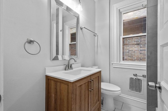 bathroom with vanity, toilet, and tile patterned flooring