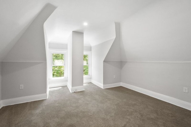 bonus room with carpet floors and vaulted ceiling