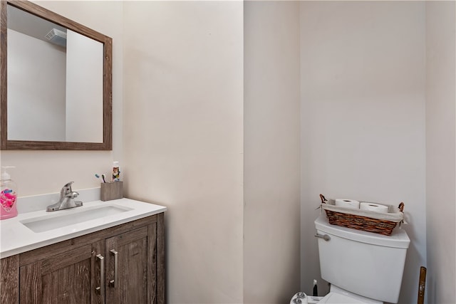 bathroom featuring toilet and vanity