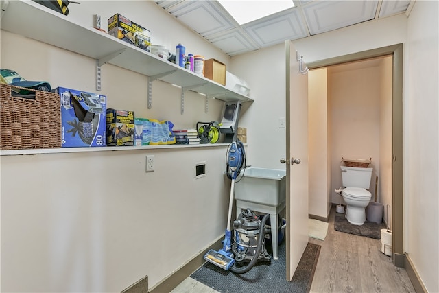 laundry room featuring light hardwood / wood-style floors and washer hookup