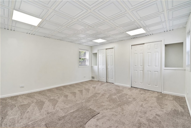 interior space featuring multiple closets and light carpet