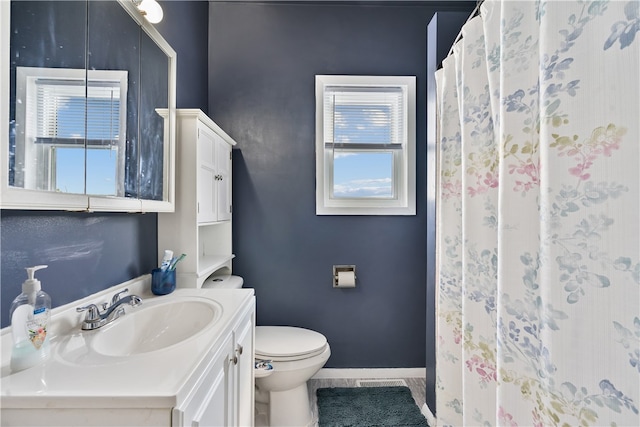 bathroom with vanity, tile patterned flooring, and toilet