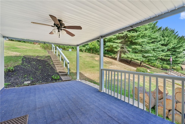 wooden deck featuring a yard and ceiling fan