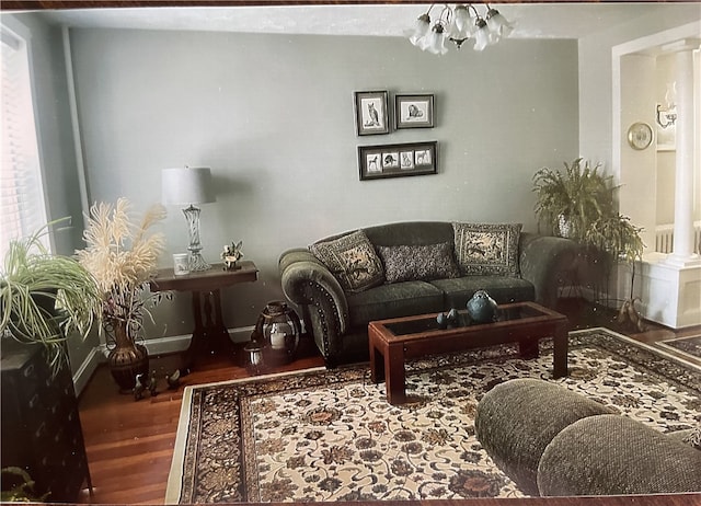 living room with a chandelier and hardwood / wood-style flooring