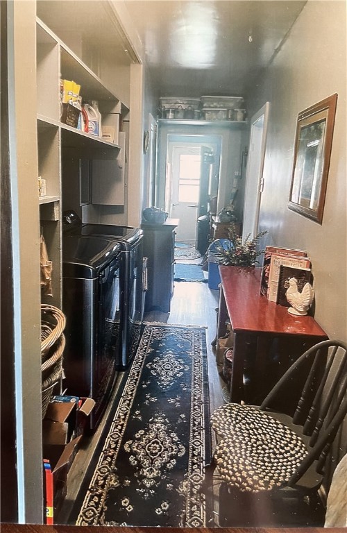 laundry room featuring washing machine and clothes dryer and hardwood / wood-style flooring