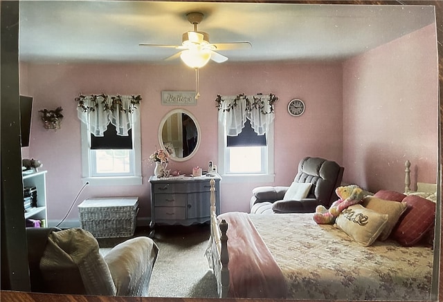 bedroom with carpet flooring, multiple windows, and ceiling fan