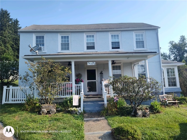 view of front of home featuring a porch and brick siding