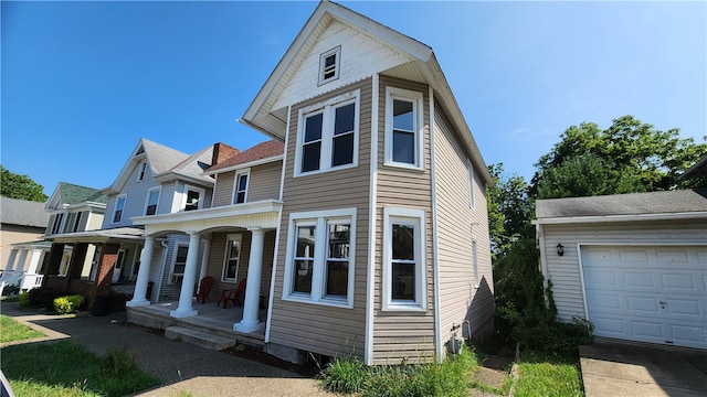 view of front facade with covered porch and a garage