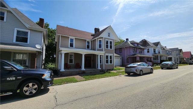 view of front of house with covered porch and a garage