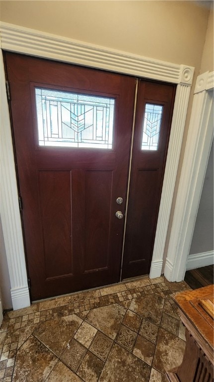 foyer entrance with tile patterned flooring and plenty of natural light