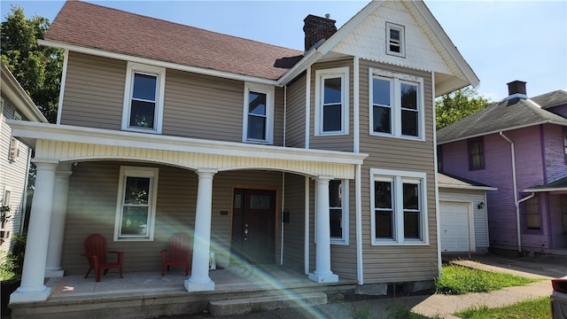 view of front of house featuring a porch and a garage