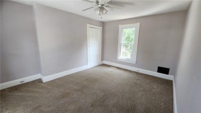 carpeted spare room with ceiling fan