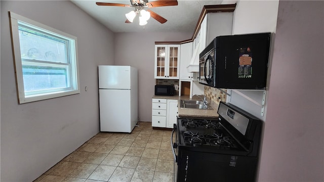 kitchen with stove, tasteful backsplash, white cabinets, white fridge, and ceiling fan