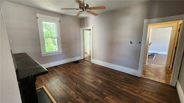 interior space with ceiling fan and dark hardwood / wood-style floors