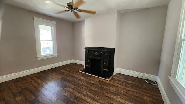 unfurnished living room with dark wood-type flooring and ceiling fan