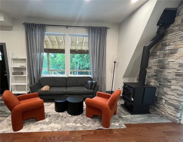 living room with wood finished floors and a wood stove