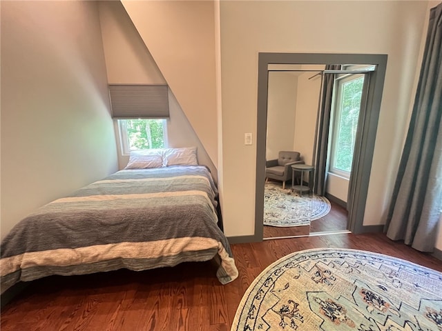 bedroom featuring baseboards and wood finished floors