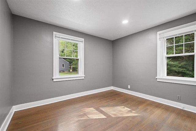 spare room with hardwood / wood-style floors