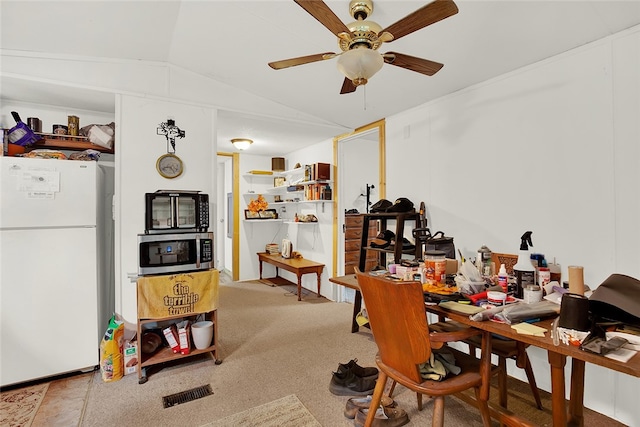 carpeted office with lofted ceiling and ceiling fan