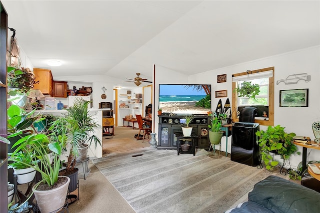 living room featuring lofted ceiling, light colored carpet, and ceiling fan