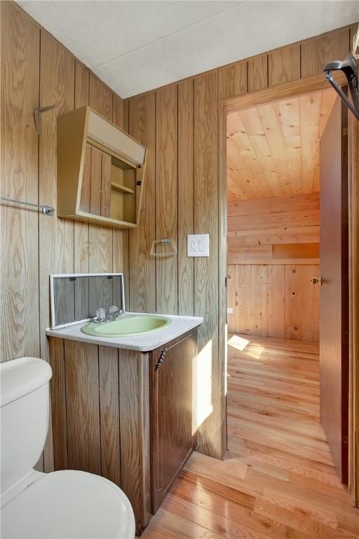 209 Challenge Ln, Indiana Twp Nal, PA 15024 - bathroom featuring wood walls, toilet, vanity, and wood finished floors
