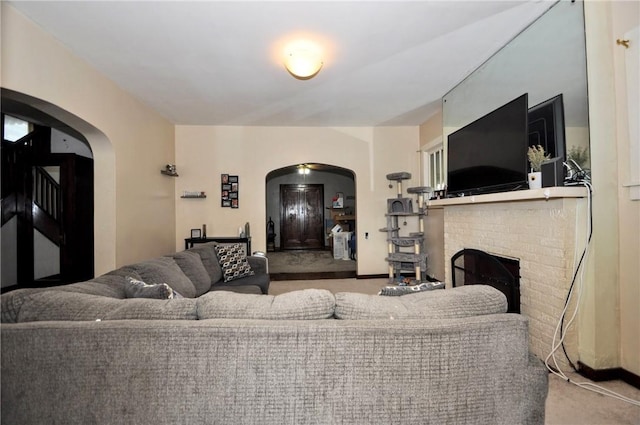 carpeted living room featuring a brick fireplace