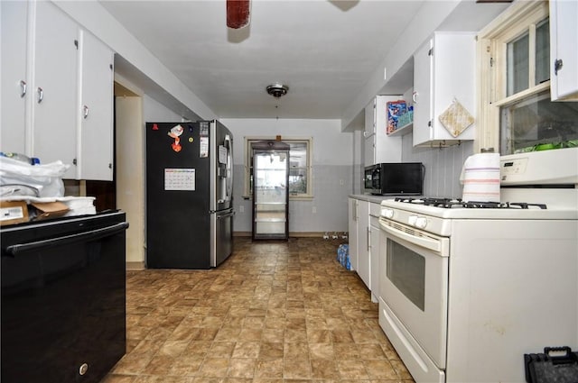 kitchen with white cabinetry, ceiling fan, and black appliances