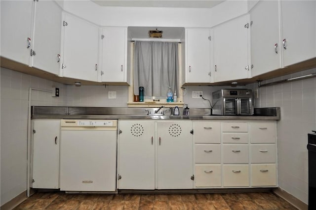 kitchen with decorative backsplash, white dishwasher, stainless steel counters, and white cabinets