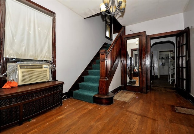 interior space with an inviting chandelier and hardwood / wood-style floors