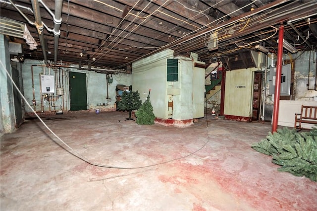 basement featuring water heater and electric panel