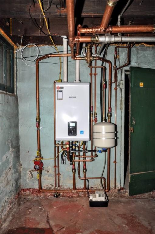 utility room featuring tankless water heater