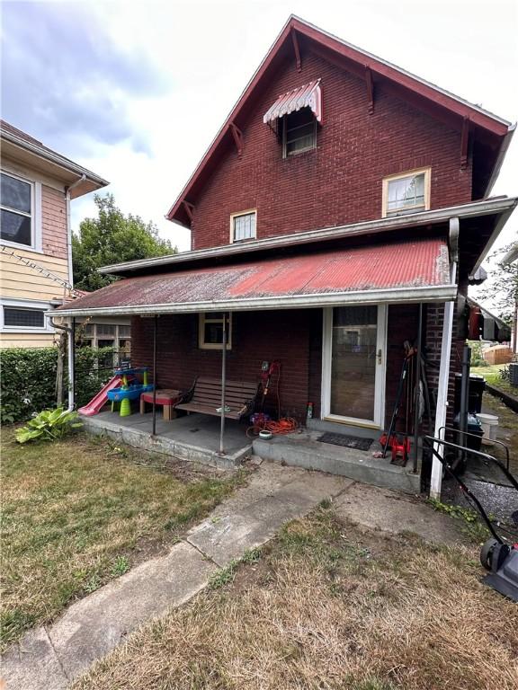 rear view of house with a lawn