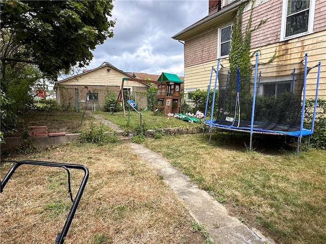 view of yard featuring a trampoline and a playground