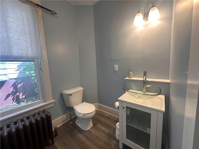 306 Shirls Ave, City Of Washington, PA 15301 - half bath featuring radiator heating unit, toilet, vanity, wood finished floors, and baseboards