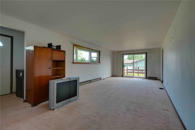 unfurnished living room featuring a baseboard radiator and light colored carpet