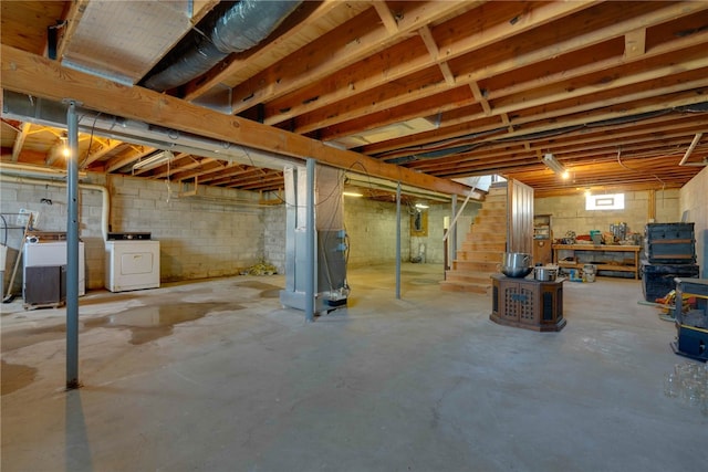 basement with washing machine and clothes dryer and sink