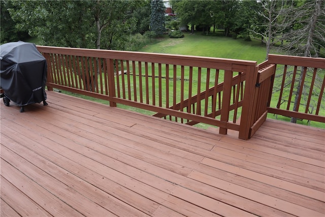 deck featuring a lawn and area for grilling