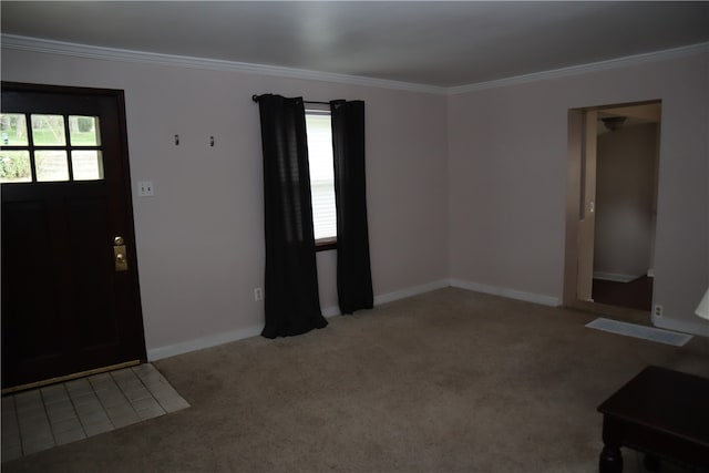 carpeted foyer entrance with crown molding