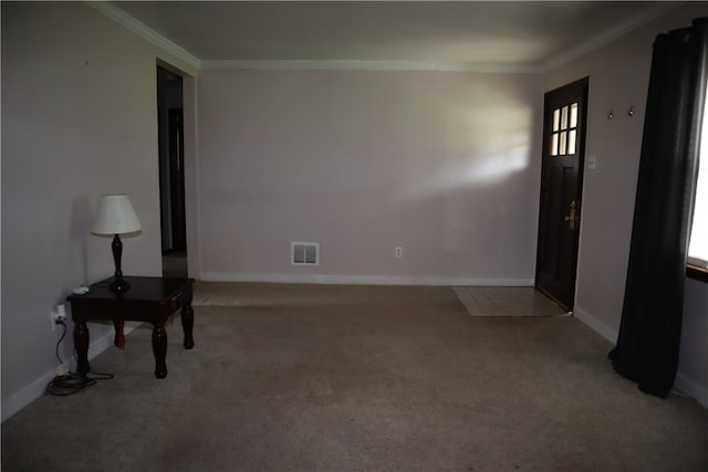 empty room with crown molding and light colored carpet