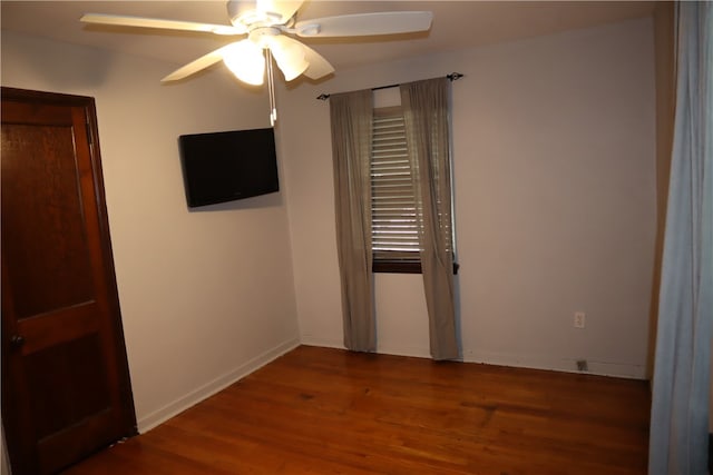 spare room featuring hardwood / wood-style floors and ceiling fan