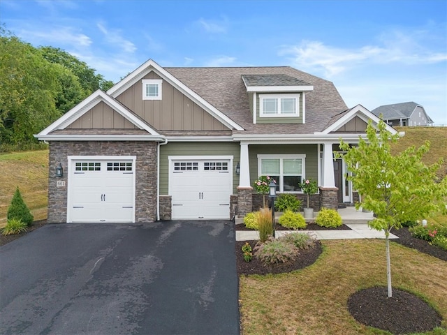 craftsman house featuring a garage and a front yard