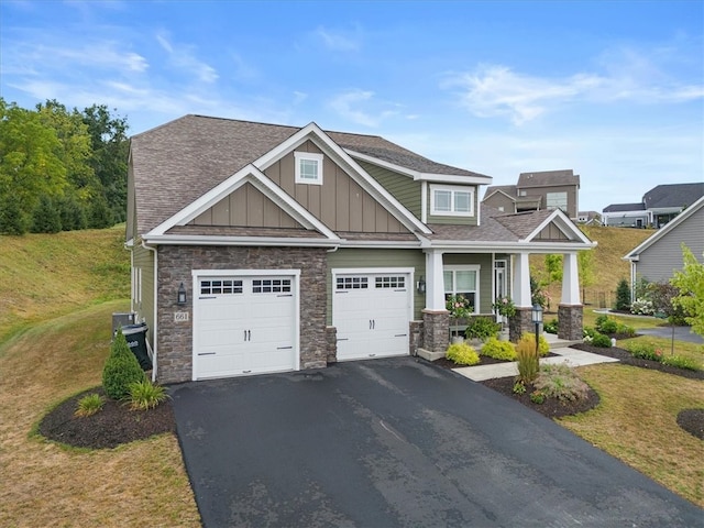 craftsman-style home with a garage and a front yard