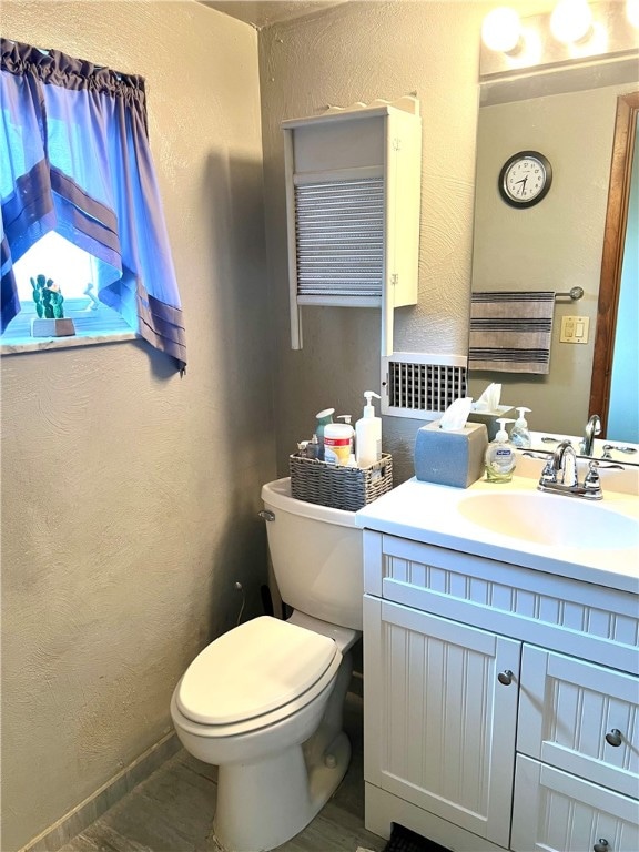 bathroom featuring hardwood / wood-style floors, toilet, and vanity