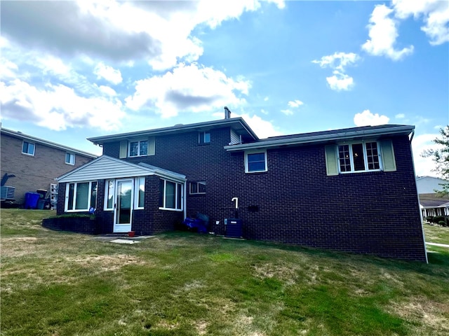 back of house featuring cooling unit and a yard